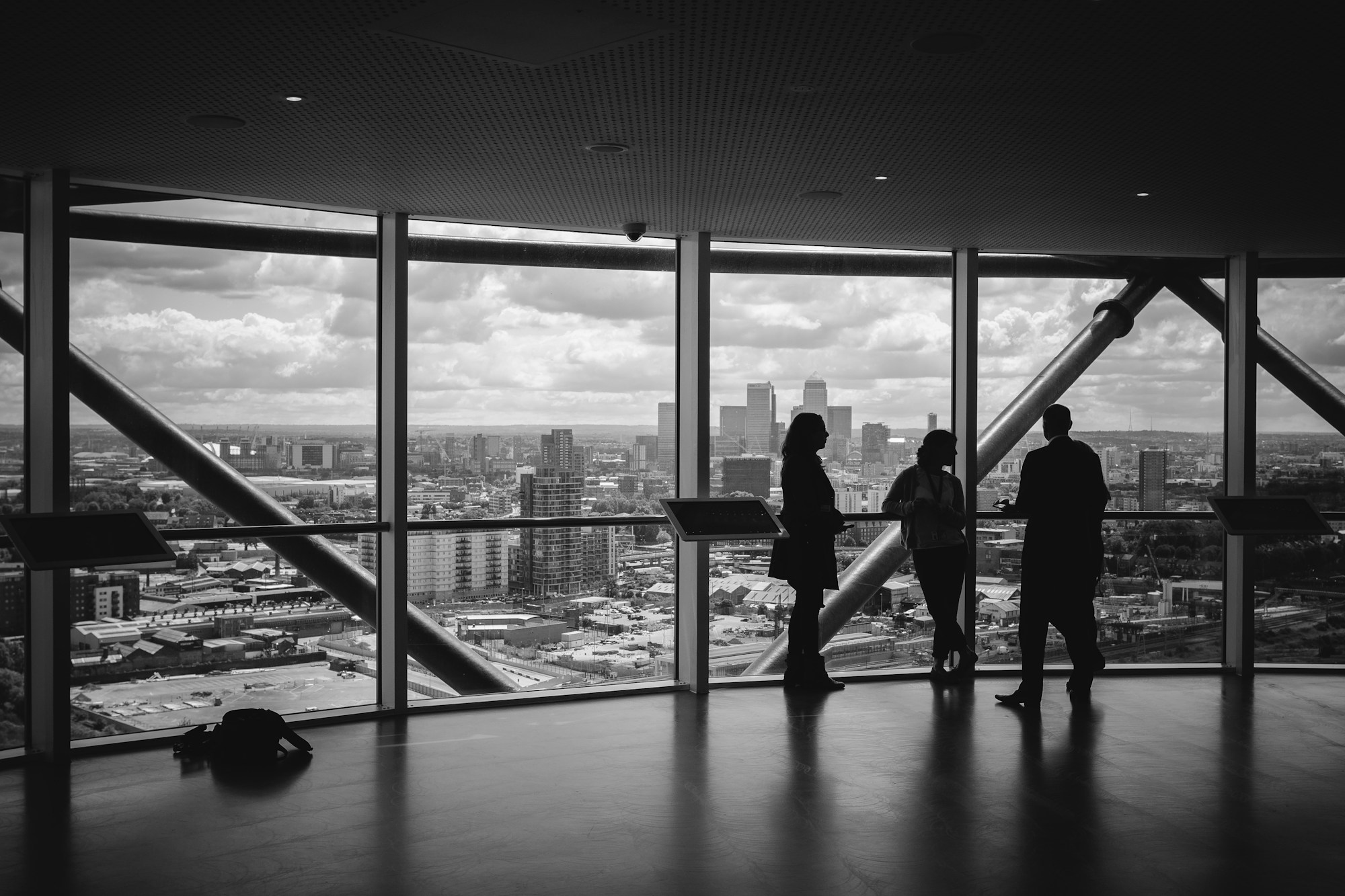 People silhouetted against a skyscraper window
